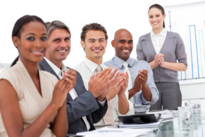 business minded people clapping their hands